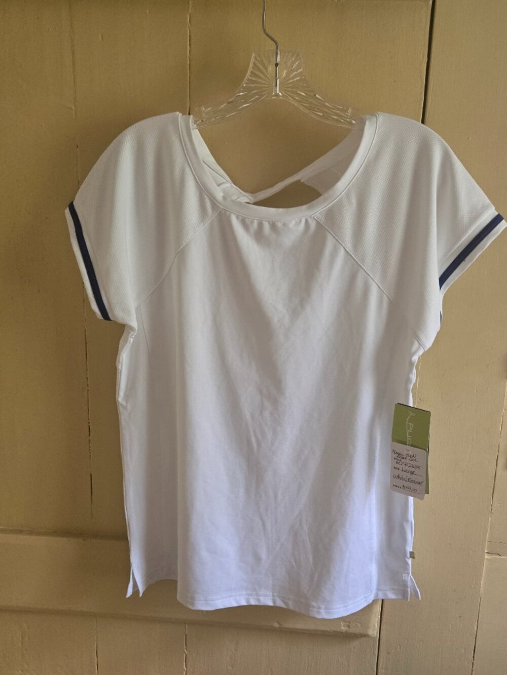 White tennis shirt with blue detail on sleeve.